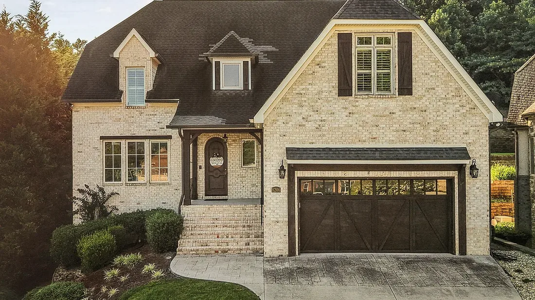 Brick and stone East Tennessee home exterior in warm evening light