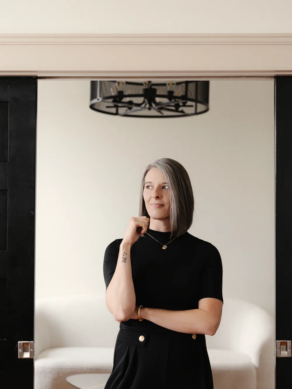 Tasha Francis standing in a doorway framed by black doors